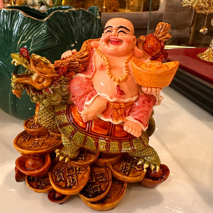 Laughing buddha with dragon and tortoise.