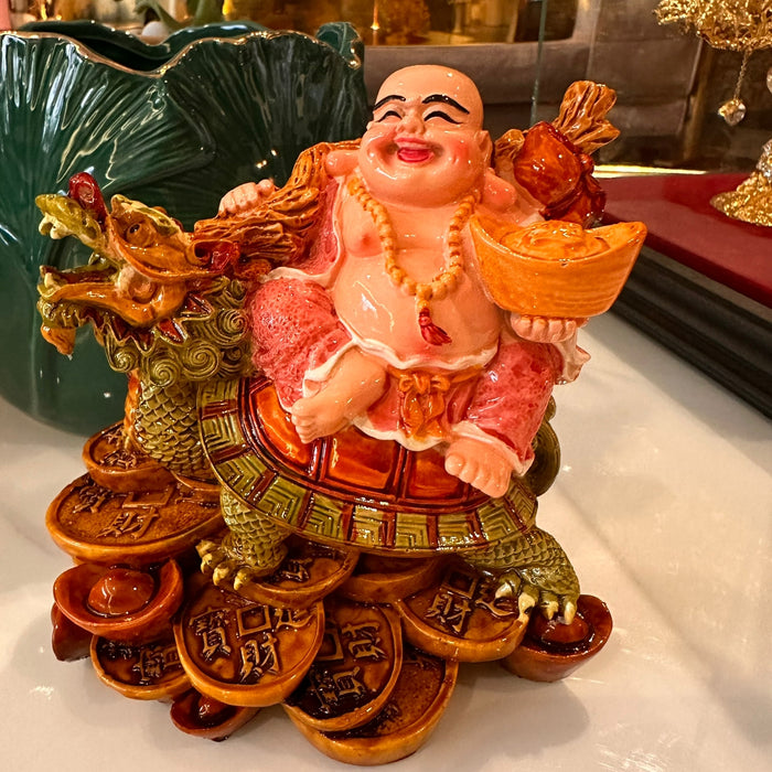 Laughing buddha with dragon and tortoise.